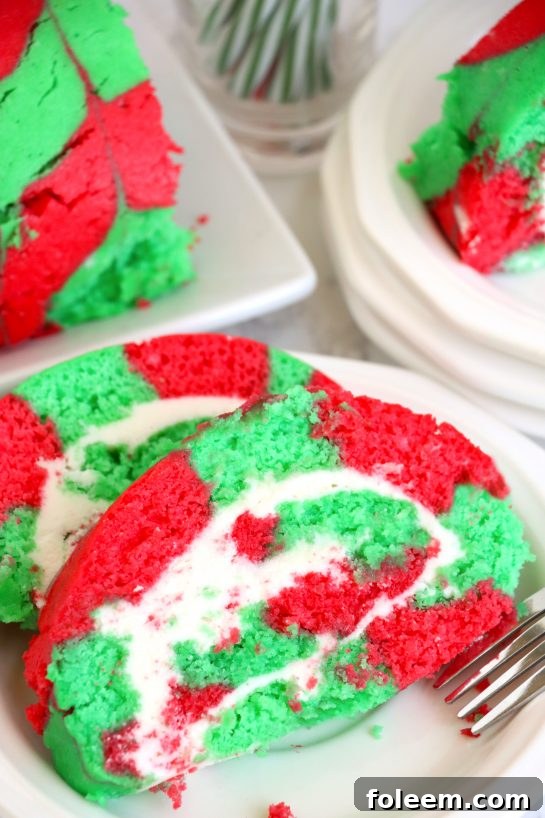 A stunning Christmas Cake Roll decorated with festive red and green colors, perfect for holiday celebrations.