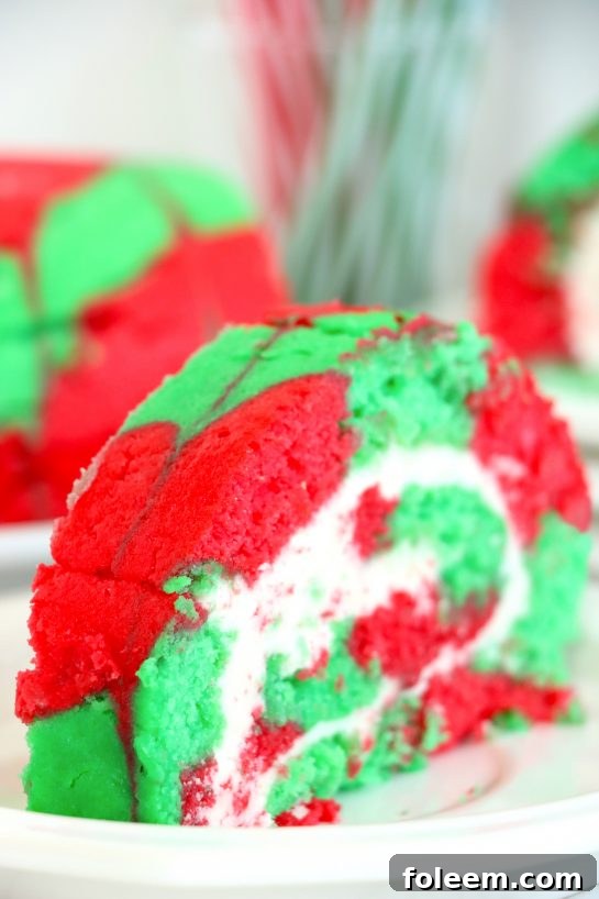 A festive Christmas Cake Roll presented on a plate, ready to be served as a delightful holiday dessert for guests.