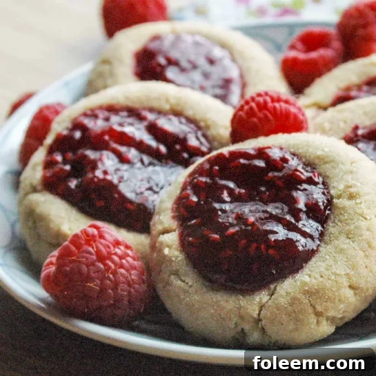 Peanut Butter and Jelly Thumbprints recipe. This recipe brings a lunchtime staple to a favorite cookie! What a wonderful combination!