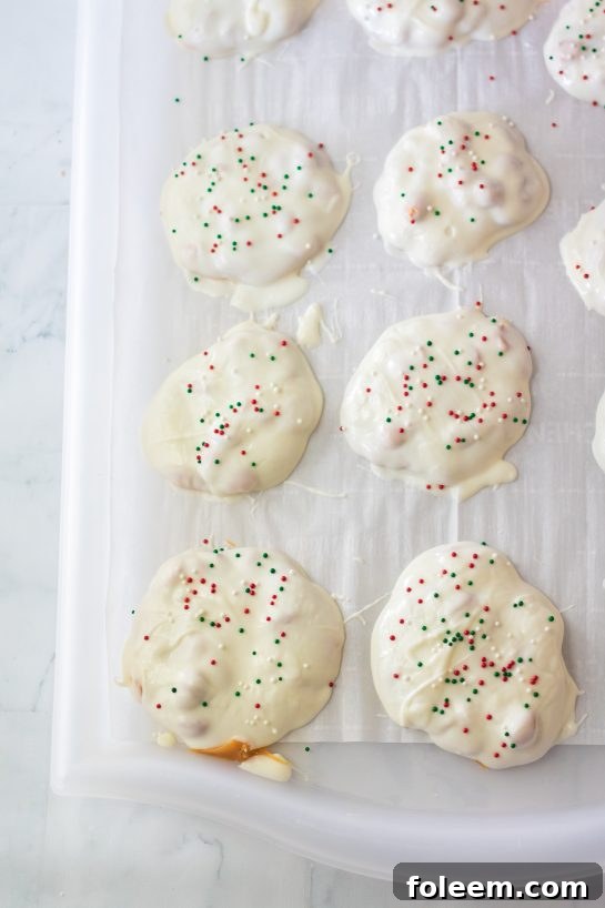 No-Bake Polar Bear Claws setting on parchment paper, ready for their white chocolate coating.