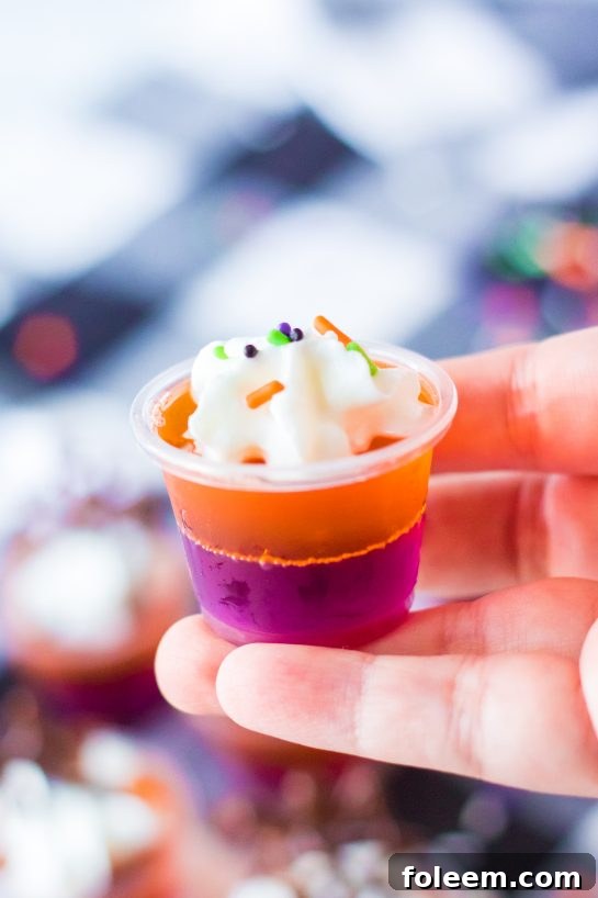 Boozy Halloween Jello Shots are a colorful and fun Halloween party idea. Learn how to make these cute Halloween shots for your next cocktail party.