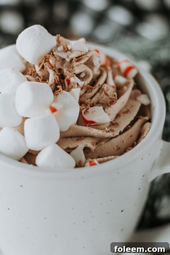 A delightful mug of creamy whipped hot chocolate, exquisitely prepared and ideal for celebrating Christmas Eve or as a special holiday indulgence.