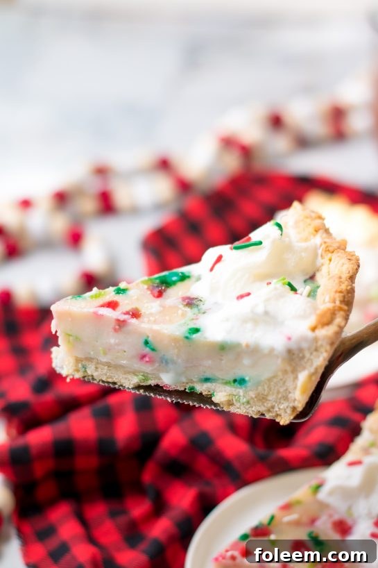This easy Christmas Sugar Cream Pie recipe is my favorite for the holidays. This is a delicious creamy pie decorated with holiday sprinkles for a festive look. The filling is silky and rich - perfect for any occasion. The crust is a no-roll pie crust which makes it fabulous to throw together for the holiday season. 