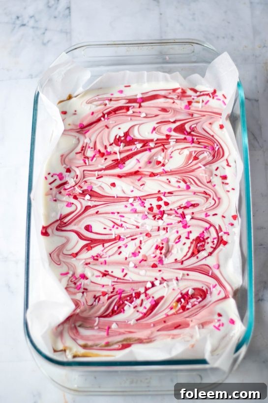 Swirling the melted chocolate onto the shortbread for the Valentine's Day Millionaire Bars recipe