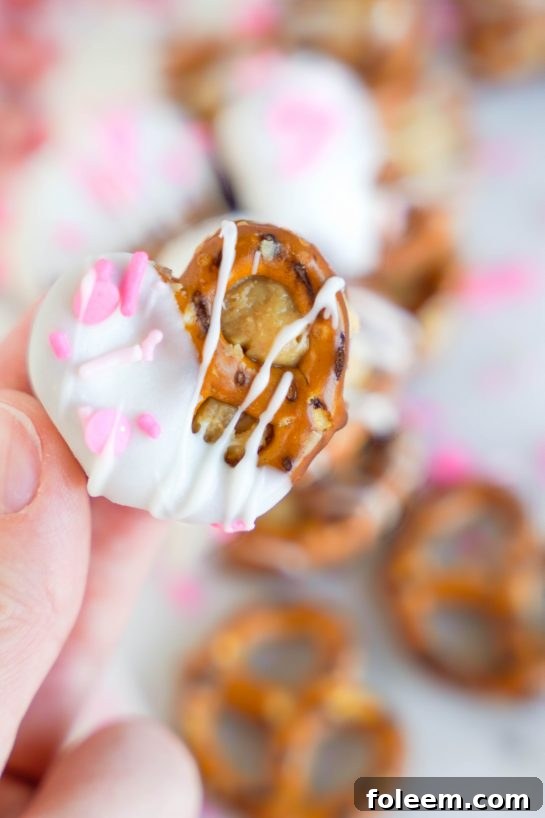 A close-up view of the delicious Valentine's Day Pretzel Bites showing the peanut butter filling and white chocolate coating