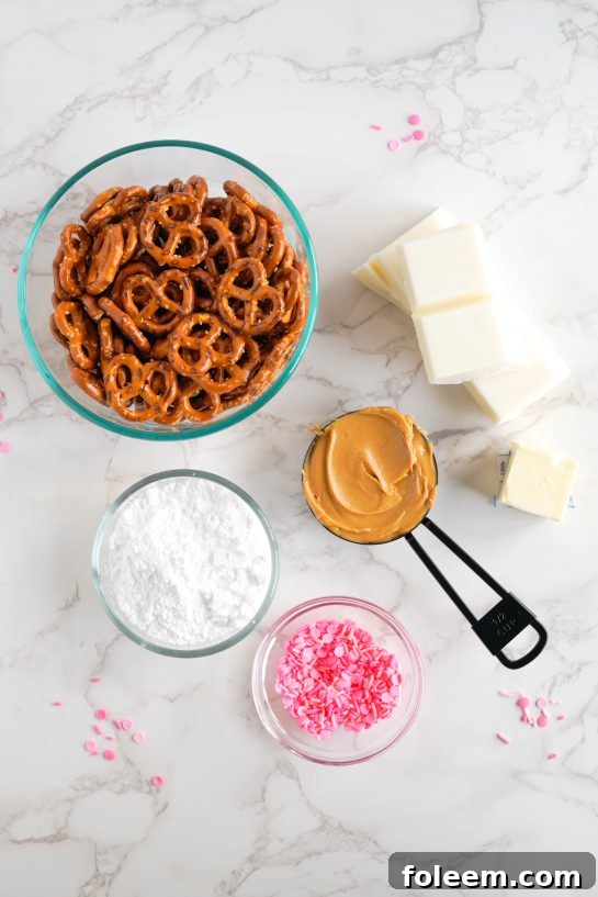 Ingredients needed to make the Valentine's Day Pretzel Bites recipe including pretzels, peanut butter, powdered sugar, butter, sprinkles, and white chocolate