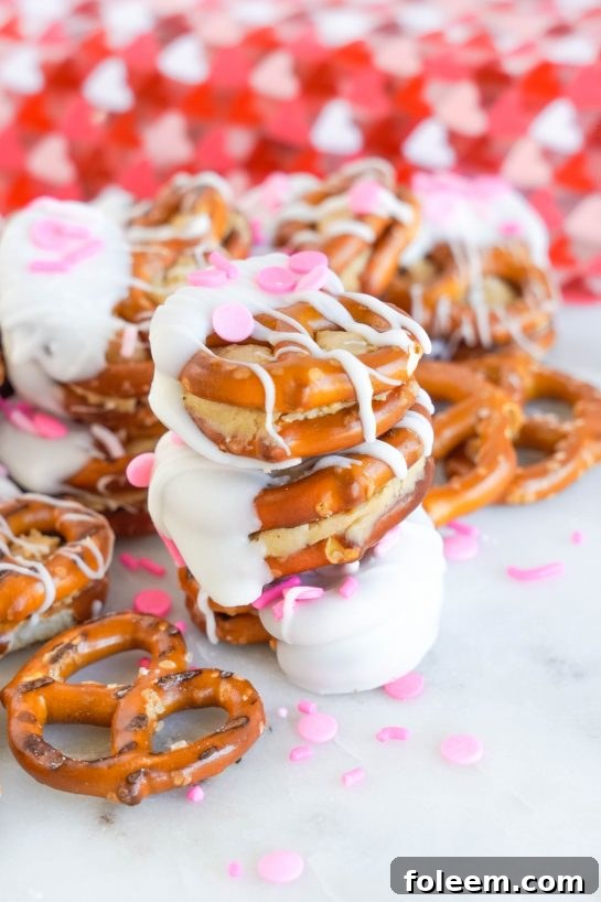 Valentine's Day Pretzel Bites are easy to make for any holiday, featuring peanut butter filling and white chocolate coating, perfect for edible gifts and parties