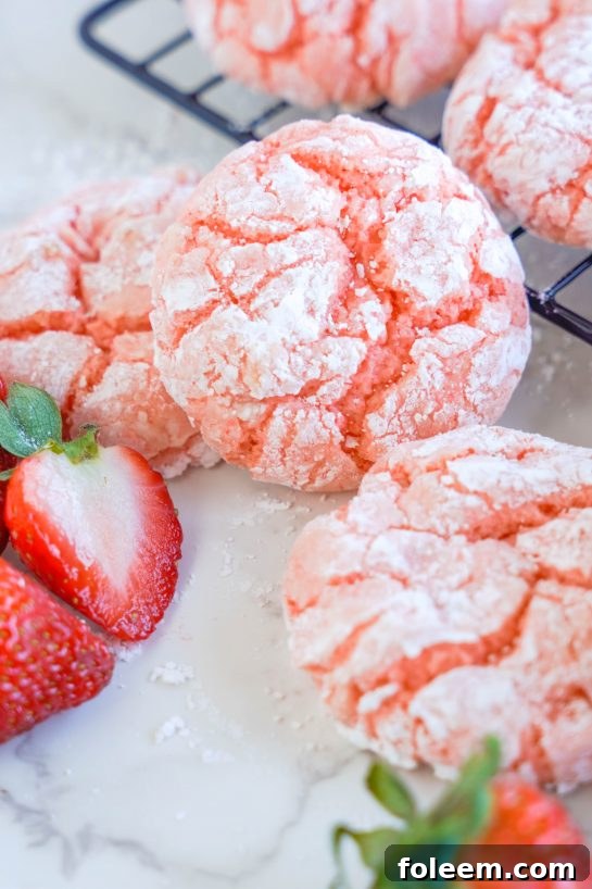 Strawberry Crinkle Cookies: an easy and delicious strawberry cookie recipe for Valentine's Day made with cake mix. If you're looking for the easiest cookie recipe on the planet, you found it! These cookies require just FIVE ingredients and come out amazing every time.