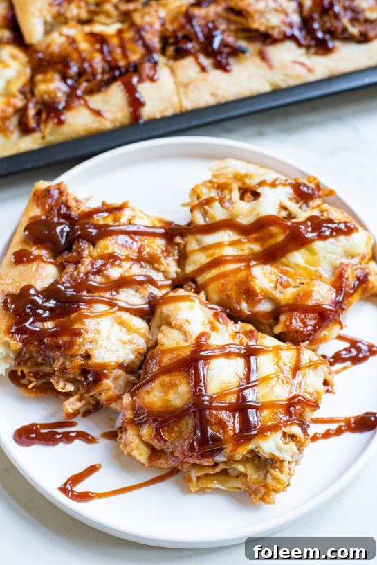 Sheet Pan BBQ Chicken Pizza with a crispy crust, melted cheese, and tender BBQ chicken, garnished for serving.