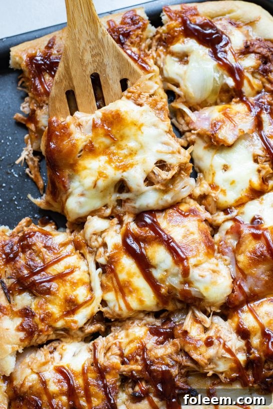 Sheet Pan BBQ Chicken Pizza, featuring a perfectly cooked crust, bubbling cheese, and tender chicken, ready to be served.