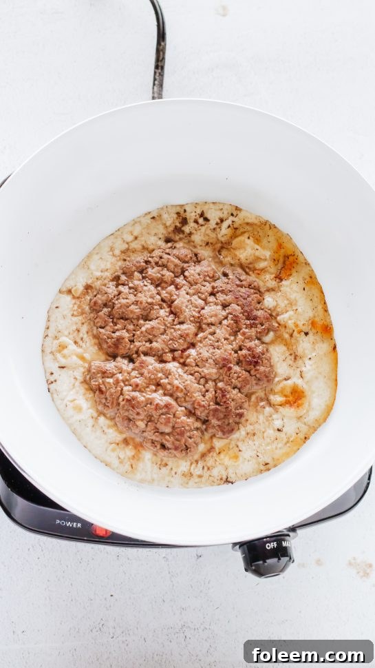 Browning ground beef or ground turkey for the Big Mac Tacos recipe in a skillet for rich flavor.