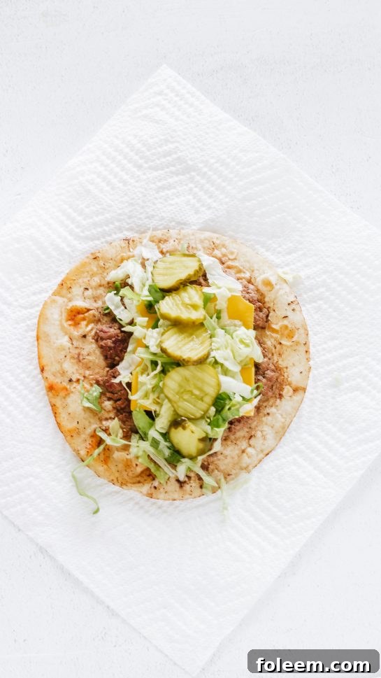 Adding crisp dill pickle chips to the ground beef or ground turkey for the Big Mac Tacos recipe.