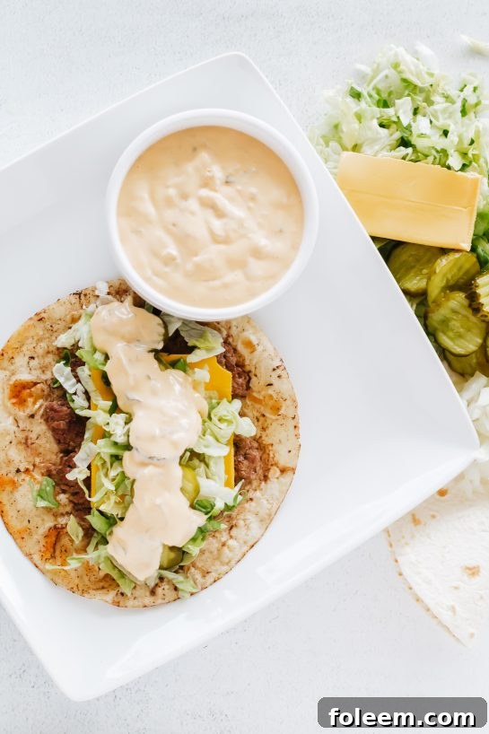 Overhead view of delicious Big Mac Tacos, loaded with beef, cheese, pickles, lettuce, and special sauce, perfect for a quick dinner.