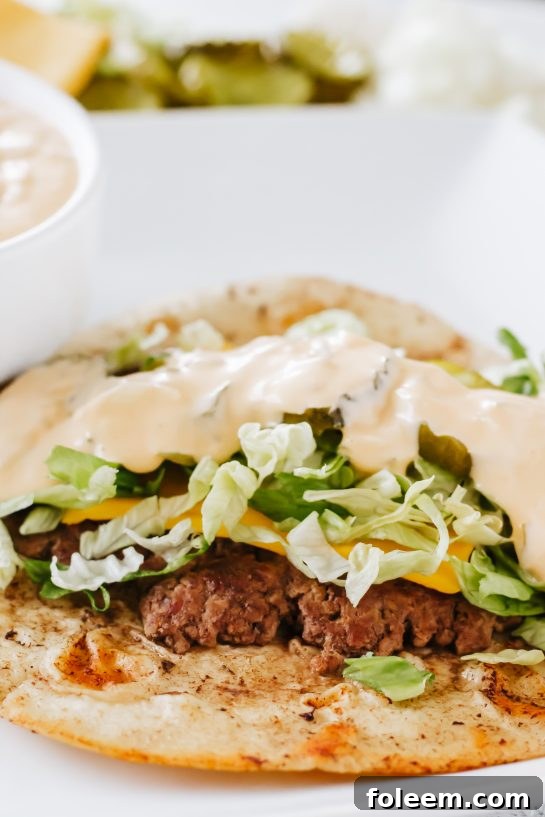 Close-up photo of a Big Mac Taco, showcasing the delicious layers of meat, melted cheese, and fresh toppings.