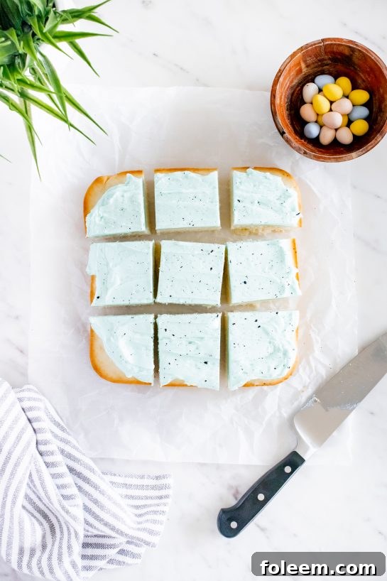 Slicing a piece of the delightful Easter Speckled Egg Snack Cake to reveal its moist interior