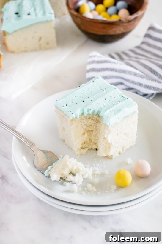 An Easter Speckled Egg Snack Cake, showcasing its charming blue color and chocolate speckles on a cake stand
