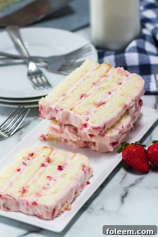 The sliced Strawberries & Cream Layered Cake recipe ready to be served for Easter dessert or a special occasion.