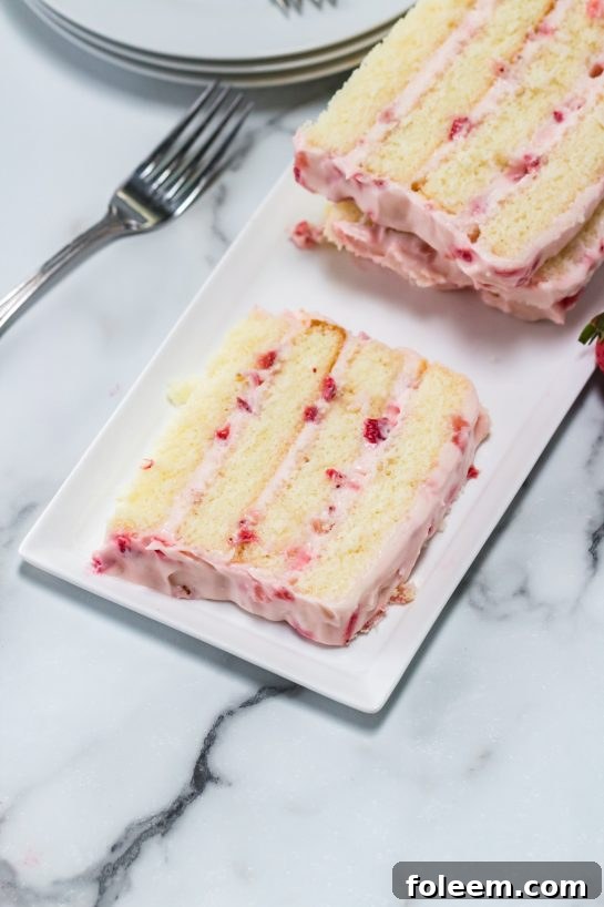 The sliced Strawberries & Cream Layered Cake recipe ready to be served for Easter dessert.
