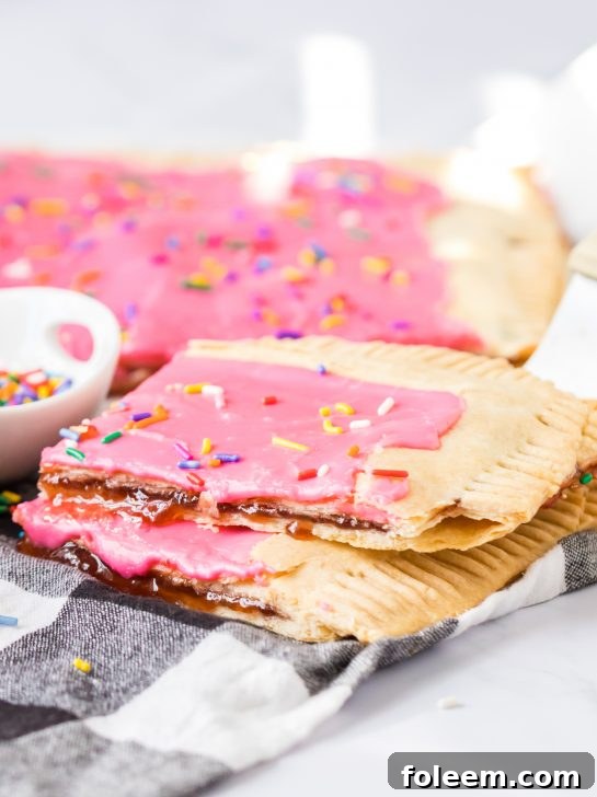 A tempting display of Easy Sheet Pan Strawberry Poptarts, featuring their golden crusts and sweet icing, ready to be enjoyed.