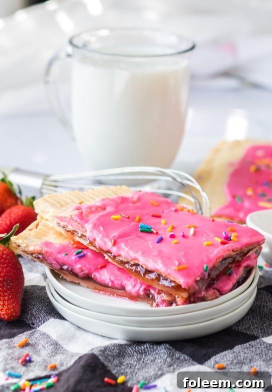 Sheet Pan Strawberry Poptarts presented on a rustic board, highlighting their perfect golden bake and colorful sprinkles.