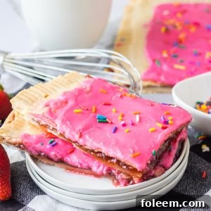 Sheet Pan Strawberry Poptarts: A delightful homemade dessert with a flaky pie crust, real strawberry jam, and colorful sprinkles. Easy to make and universally loved!