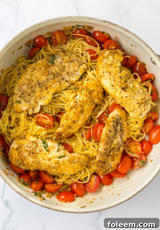 Adding the seasoned chicken to the tomato mixture for the Bruschetta Chicken Pasta recipe 