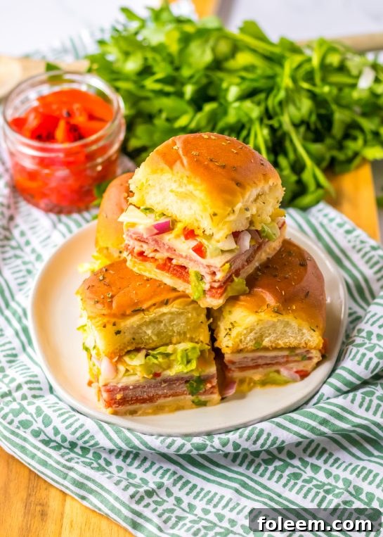 Overhead shot of a full platter of Italian Sub Sliders, garnished and ready to serve.