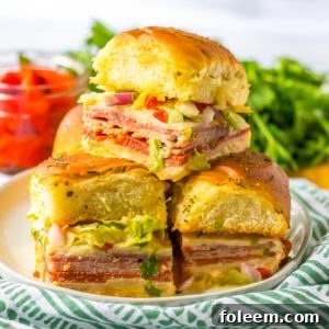 A complete Italian Sub Slider, highlighting the layers of meat, cheese, and fresh toppings.