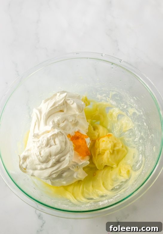 Mixing the ingredients needed to make the candy corn lush for fall dessert recipe