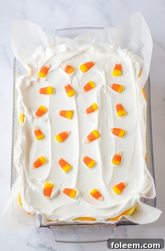 Adding on the candy corn garnish needed to make the candy corn lush for fall dessert recipe