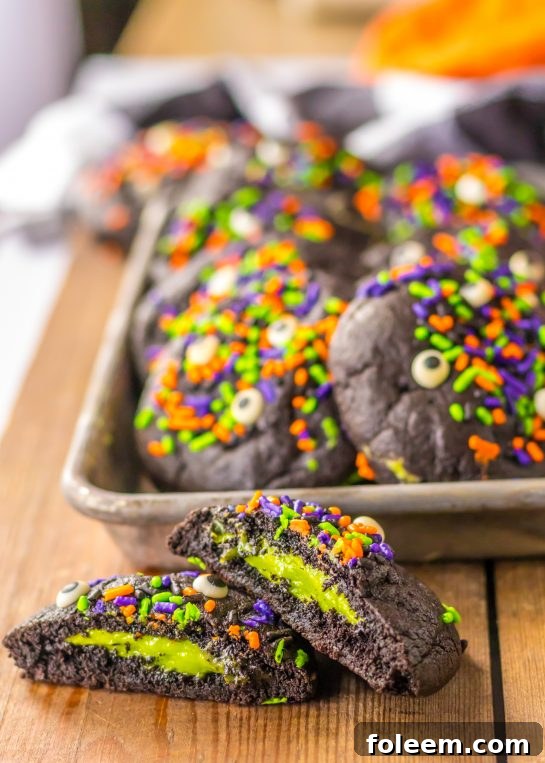 These Stuffed Black Velvet Cookies are perfect for a Halloween dessert recipe. Dark chocolate cookies are stuffed with a creamy cheesecake filling that is so delicious. Halloween sprinkles top off these spooky cookies that everyone will love at your party.