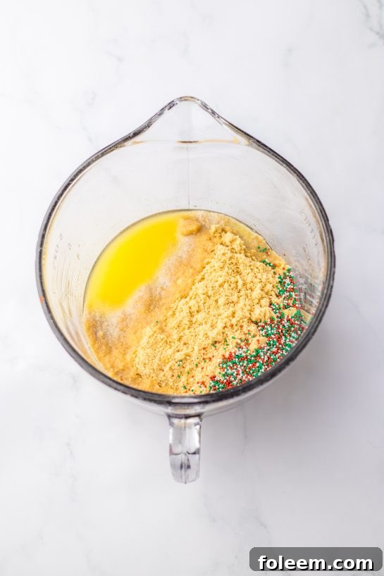 Mixing wet and dry ingredients for the Christmas Cookie Lush recipe, a simple step towards a delicious no-bake treat.
