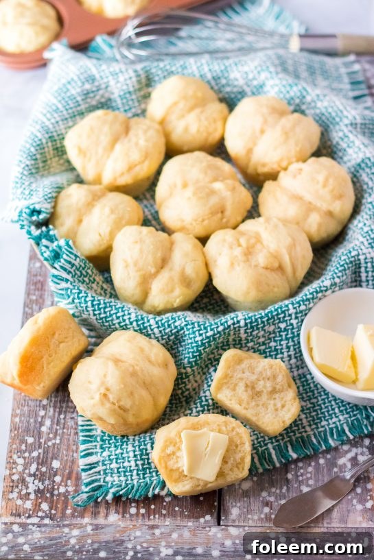 An inviting overhead photo of freshly baked, buttered Mashed Potato Rolls arranged on a serving plate, ready for a delicious Thanksgiving dinner.