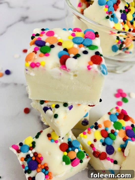 Sugar Cookie Fudge is a rich and creamy vanilla cookie dough fudge recipe. Made from eggless sugar cookie dough, this easy fudge tastes just like sugar cookies! This no bake fudge comes together quickly and will soon be your new favorite for Valentine's Day or any holiday!