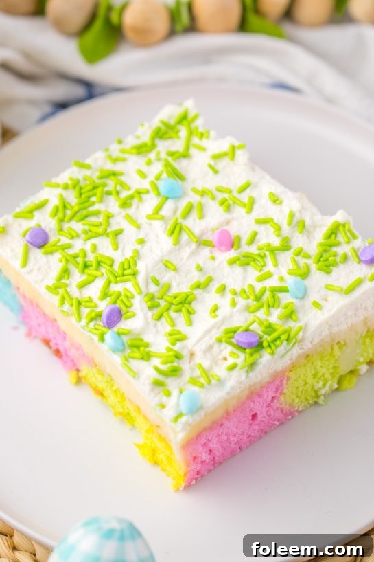 The final Easter Poke Cake, a delightful spring dessert with colorful cake, white chocolate pudding, and luscious whipped cream topping.