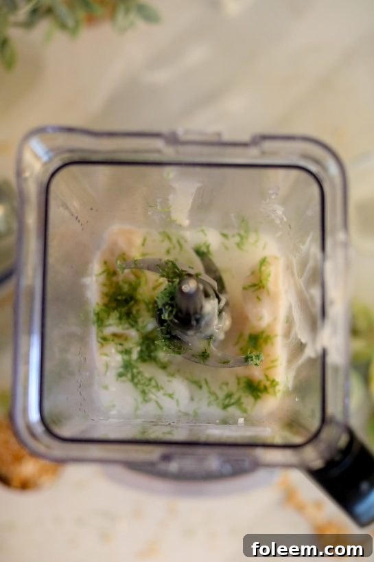 The vital step of blending fresh lime zest into the Coconut Lime Frozen Margaritas recipe, infusing an extra layer of aromatic citrus complexity and brightness into the final drink.