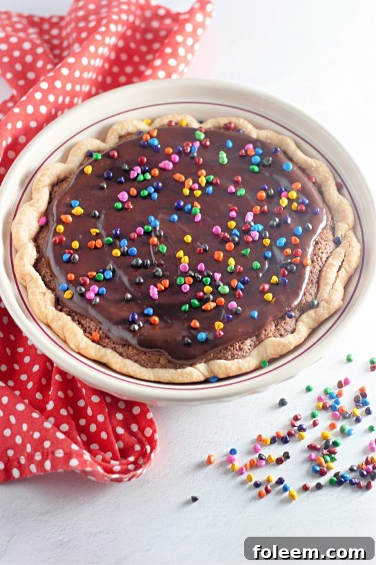 A beautifully baked Cosmic Brownie Pie, a decadent chocolate dessert with vibrant sprinkles, ready to be enjoyed.
