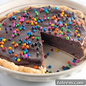 Easy Cosmic Brownie Pie recipe is a small slice of chocolate heaven in a recipe. This photo shows a slice taken out of the pie.
