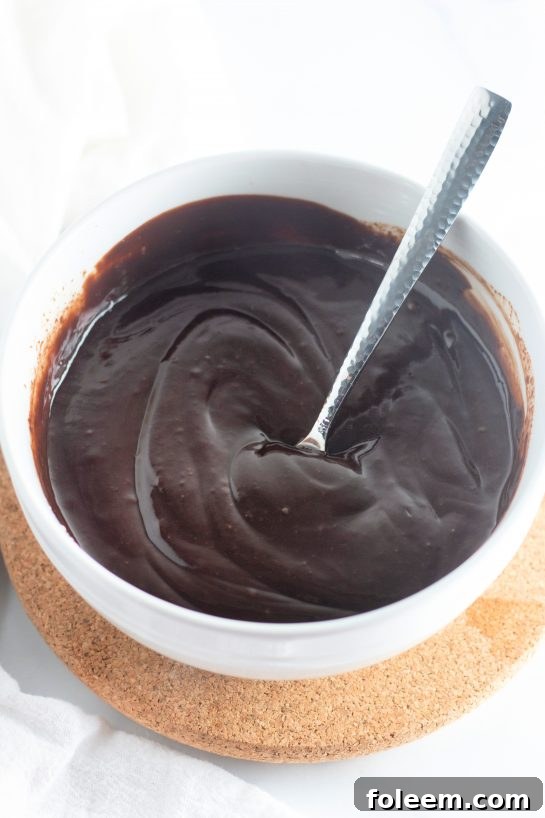 A large mixing bowl containing the rich, dark brownie batter for the Cosmic Brownie Pie, mid-preparation.