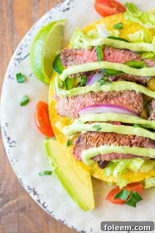 Easy Steak Tostada Salad recipe has a Mexican twist and is the steak salad of your dreams! It's loaded with a juicy steak, your favorite veggies, and a creamy cilantro-lime vinaigrette. It makes a delicious healthy lunch or dinner salad!