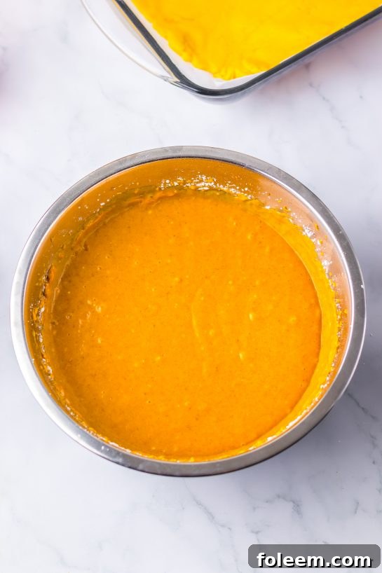 Mixing the ingredients for an easy Pumpkin Gooey Butter Cake