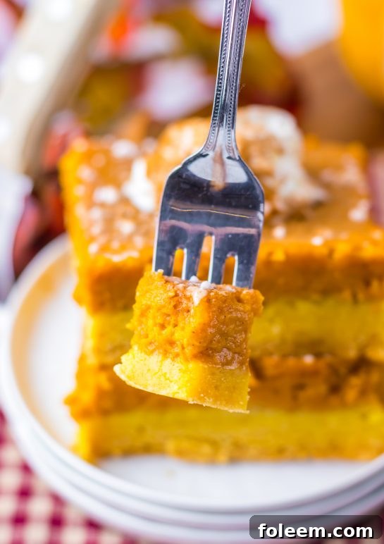 Close-up of a slice of Pumpkin Gooey Butter Cake on a fork