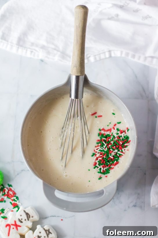 Hands mixing ingredients in a bowl, preparing the Christmas Poke Cake batter.
