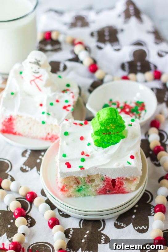 The finished Christmas Poke Cake, showcasing its festive decoration with whipped cream and sprinkles.