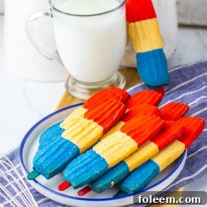 This recipe for Bomb Pop Cookies is not only so tasty but so cute for the 4th of July! These are the perfect dessert to bring for those red, white and blue holidays. Bursting with Sugar cookie flavors with hints of cherry flavoring in the red and blueberry flavoring in the blue, using Jello! These were so fun to make and were a huge hit for everybody involved!