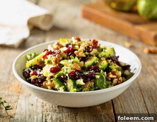 Close-up of a vibrant Brussels Sprouts Cranberry Walnut Salad, showcasing fresh ingredients and rich textures.