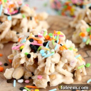 White Chocolate Halloween Crock Pot Candy with chow mein noodles, white chocolate bark, and Halloween sprinkles.