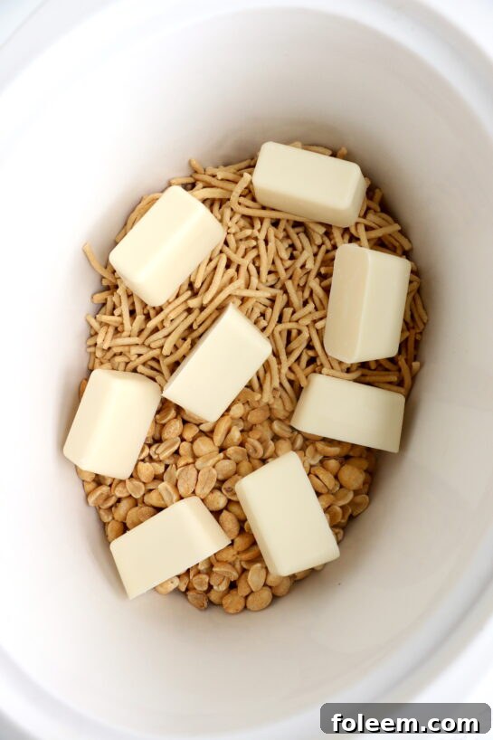 Melting white chocolate bark in a slow cooker for easy Halloween Crock Pot Candy.