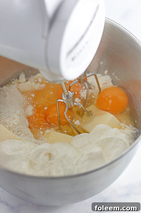 Mixing the ingredients needed to make the Honey Bun Cake recipe for the holidays