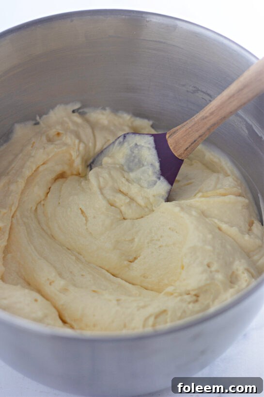 Mixing the frosting to make the Honey Bun Cake recipe for the holidays